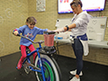 Elementary students rides a bike that makes smoothies